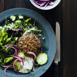 Lamb sliders on a plate with salad and pickled onions