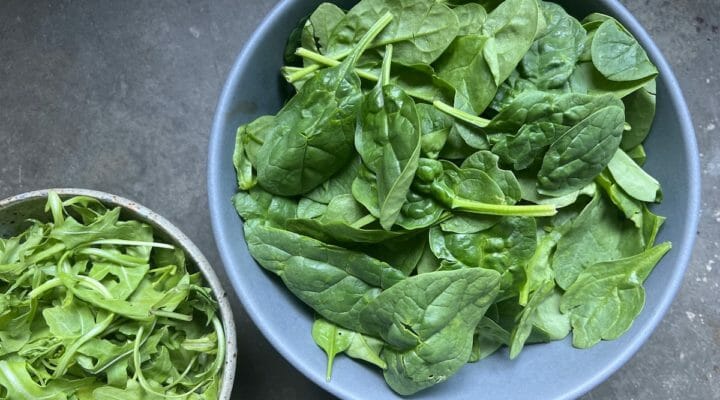 two bowls of dark leafy greens