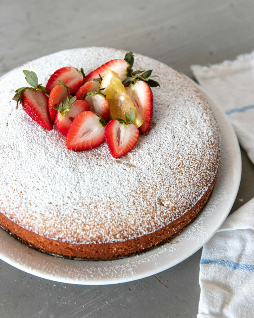 close up of olive oil cake with strawberries on top