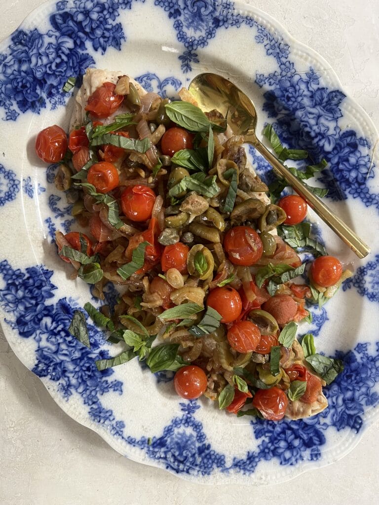 Easy fish cooked in parchment with tomatoes, capers, fennel and olives 